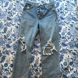 Size 25 Agolde jeans with rips on both knees. Washed light blue and straight fit